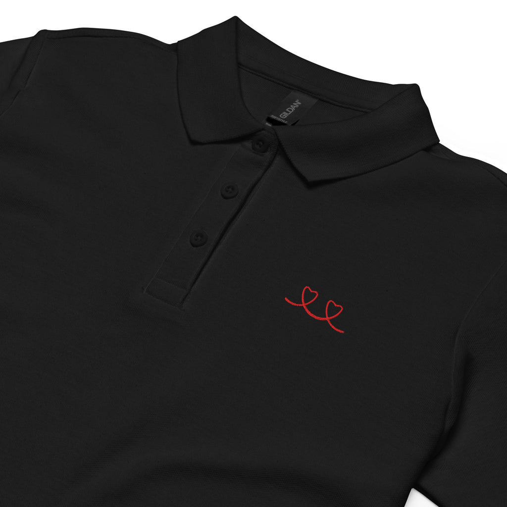 Black polo shirt with red love smiley embroidered on the left of shirt on white background