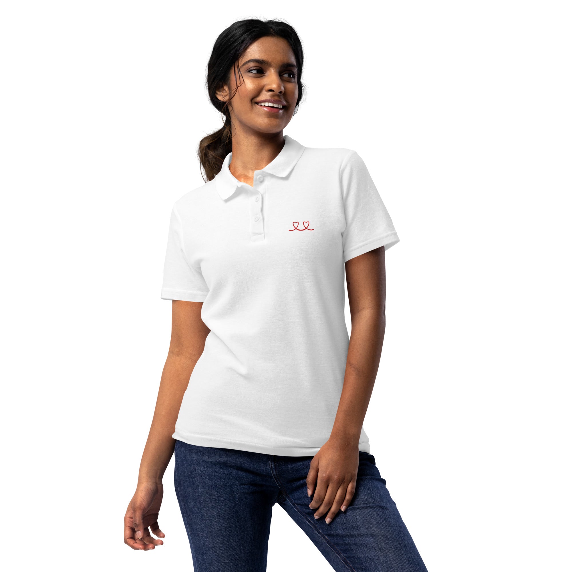 Woman wearing a white polo shirt with a red love smiley embroidery and a blue denim skirt on a white background