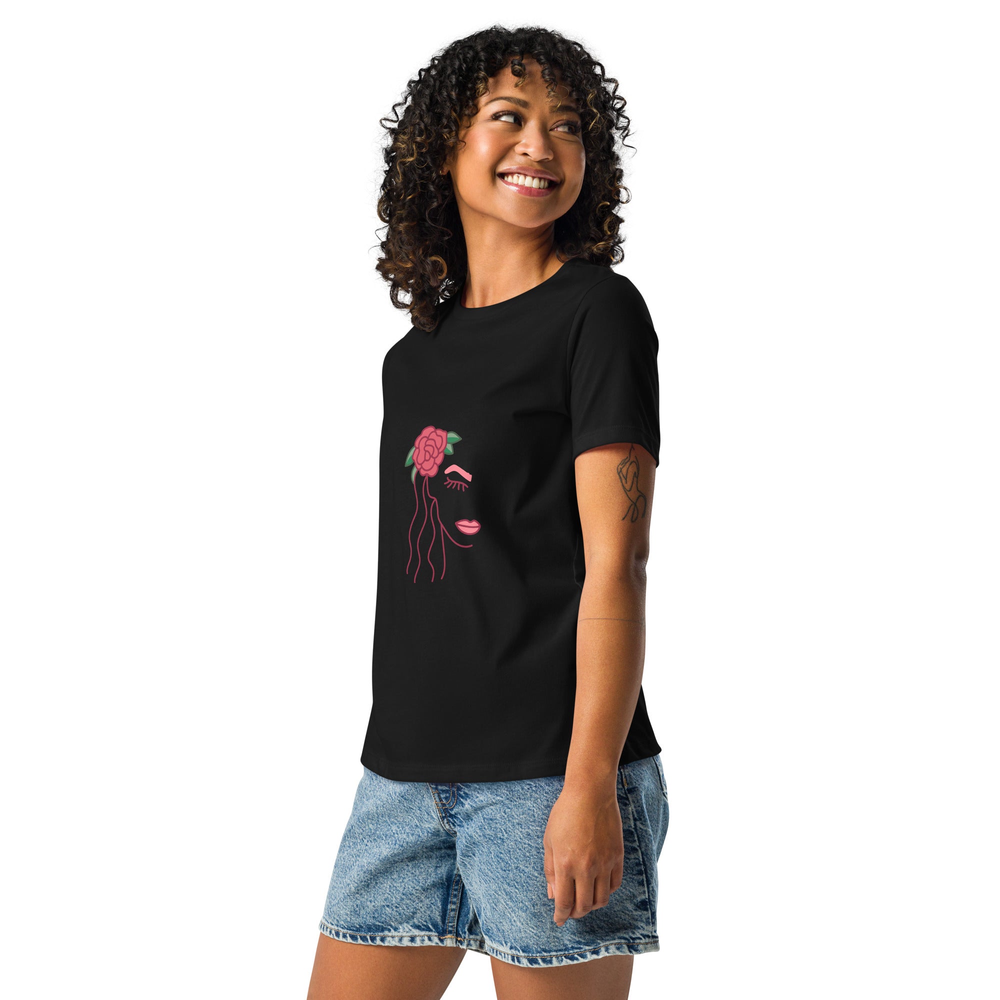 Woman wearing a black t-shirt with a colorful graphic design on a white background